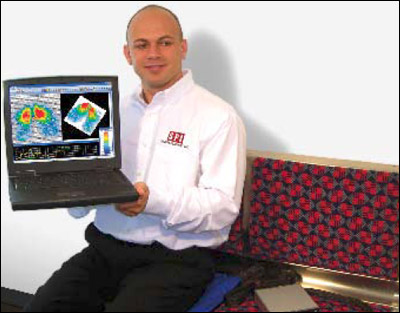 Vadim Shaylt of Sensor Products Inc sits on the Blue Tactilus Pad connected to a hub, which wirelessly transmits the surface pressure data to the laptop