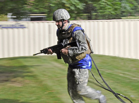 Soldier running in a field being tested with sensor system