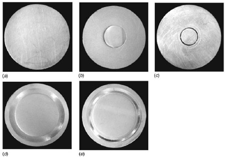 Fig. 5 CuZn30 brass disk after lapping and polishing: (a) reports the disk without indent, (b) the disk with the small area indent, (c) the disk with the small area indent after the test, (d) the disk with a large area indent, and (e) the disk with a large area indent after the test. The pictures taken after the test clearly show that the contact area (brighter ring) is inside the indent.